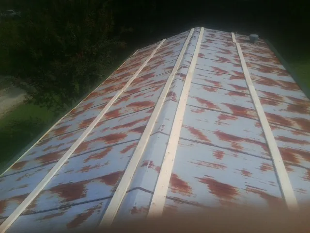 Rusted metal roof panels with new wood purlins before replacement — Storm Damage Roof Repair in Prosser by Roofing Brothers