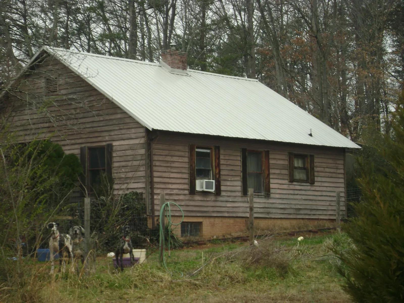White metal roof on an old wood sided farmhouse, from a Metal Roof Installation job in Prosser